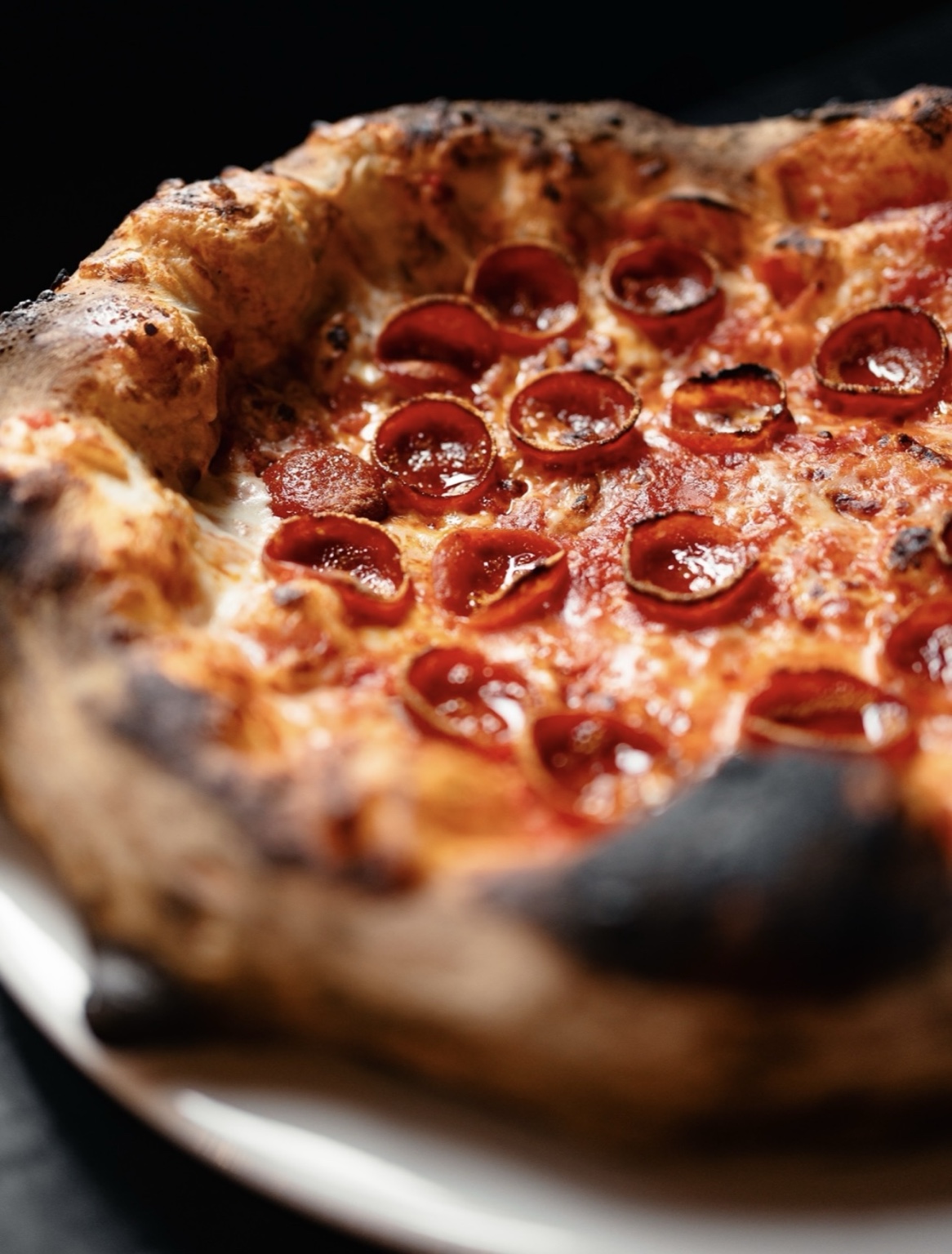 Close-up of a freshly baked cup and char pepperoni pizza
